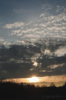 Natural sunset or sunrise. Bright dramatic Sky. Countryside Landscape under Scenic Colorful Sky at Sunset. Sun over skyline, Horizon