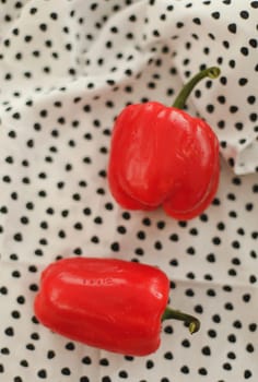 Sweet red peppers on towel on a white table top view