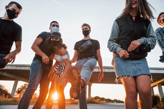 Group of young cheerful friends having fun together. Party outdoors.