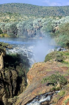 The Epupa Falls (also known as Monte Negro Falls in Angola) are created by the Kunene River on the border of Angola and Namibia, in the Kaokoland area of the Kunene Region. The river is 0.5 km wide and drops in a series of waterfalls spread over 1.5 km, with the greatest single drop being 37 m.The name "Epupa" is a Herero word for "foam", in reference to the foam created by the falling water. Afica, Namibia,Kaokoland, Kunene province