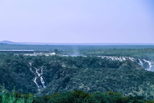 Panoramic view of Ruacana Falls. Located near Ruacana on the Kunene River in Northern Namibia. The waterfall is 120 meters (390 ft) high and 700 meters (2,300 ft) wide in full flood. It is among the largest waterfalls in Africa, both by volume and width. Africa, Namibia, Kaokoland