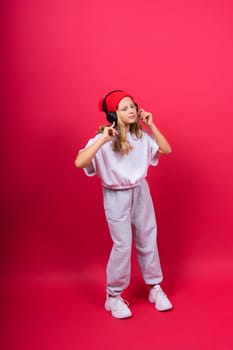 Child music concept. Teenager girl dance in rhythm of melody, listens song in headphones