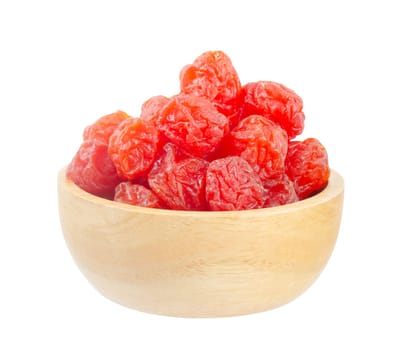 Dried red prunes fruits (Preserved fruits Chinese plum) in wooden bowl isolated on white background, save clipping path.