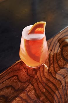 Grapefruit inside. Close up view of fresh summer cocktail on the wooden table.