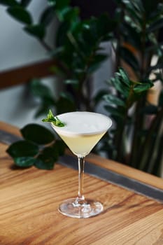 Green mint and yellow lime. Close up view of fresh summer cocktail on the wooden table.