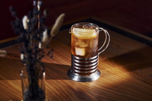 Ice cubes inside. Close up view of fresh summer cocktail on the wooden table.