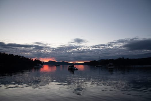 Sunset over a beautiful anchorage with boats in the water in Winter Cove, Gulf Island Marine Park, Vancouver Island, Canada