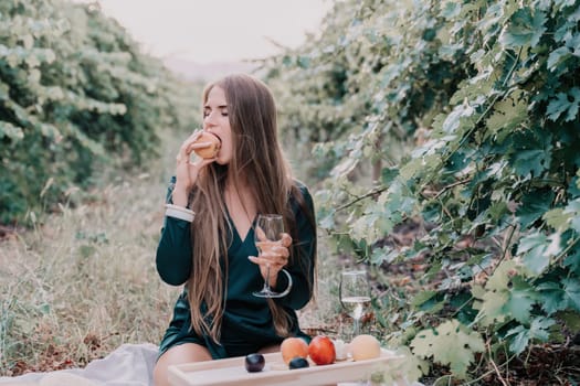 Picnic and wine tasting at sunset in the hills of Italy, Tuscany. Vineyards and open nature in the summer. Romantic dinner, fruit and wine.