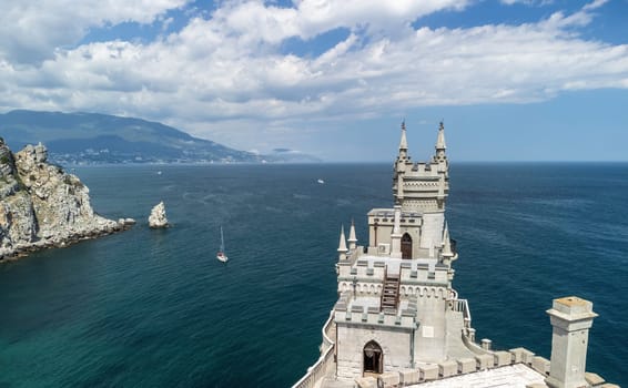 Aerial view of Swallow's Nest castle on the rock in Black Sea. It is a symbol and landmark of Crimea. Beautiful scenic panorama of the Crimea coast. Amazing Swallow's Nest at the precipice.