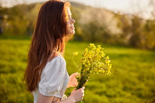 portrait of a woman standing sideways to the camera during sunset with a bouquet of wildflowers. High quality photo