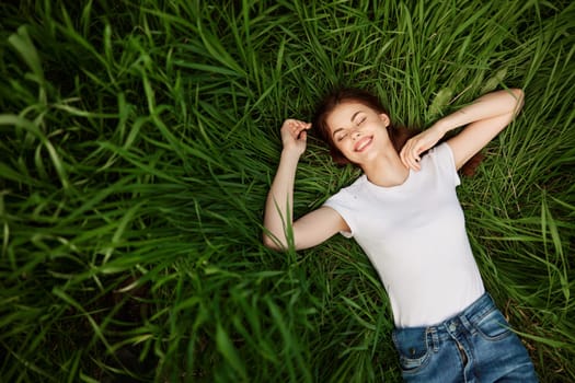 carefree woman spends day lying in tall grass. High quality photo