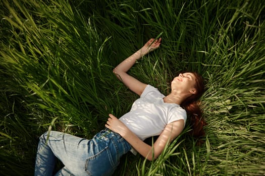 woman resting from worries lying in tall grass. High quality photo