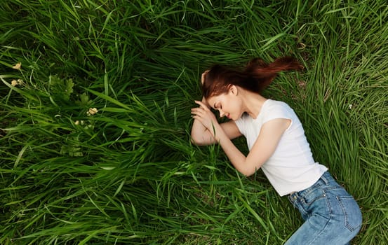 calm, peaceful woman falls asleep in tall grass. High quality photo