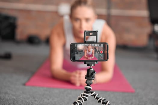 Live streaming, fitness and phone of woman exercise, pilates or workout on social media or video platform on tripod. Gen z athlete, sports influencer or content creator training on smartphone screen.