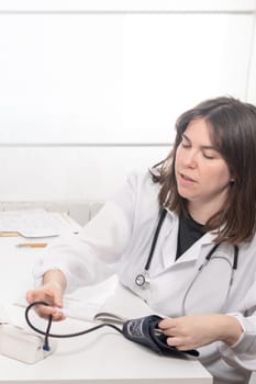 young doctor preparing the Blood Pressure Cuff or sphygmomanometer for use in your medical office