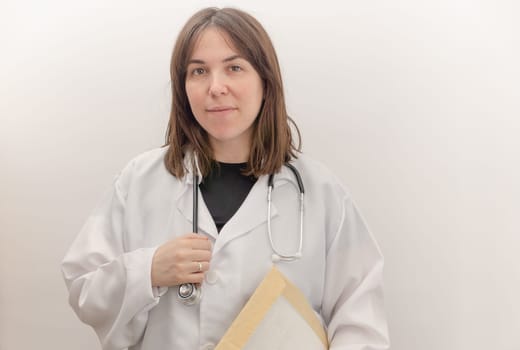 young doctor with white coat and stethoscope, white background and copy space