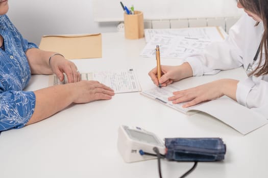 woman doctor writing a prescription to her patient at the doctor's office