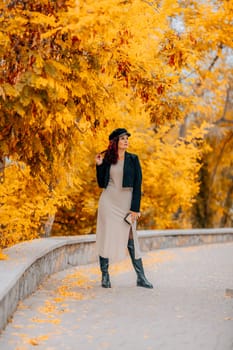 A woman walks outdoors in autumn, enjoys the autumn weather