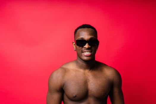 Like what you see. A handsome and muscular young man posing in a studio.