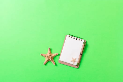 blank notebook with seashell for summer holiday green background , Top view Flat lay concept.