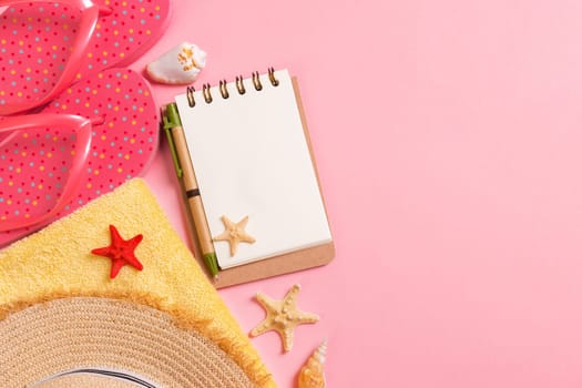 Flat lay, top view Travel concept. summer accessories with note paper and seashell on pink background.