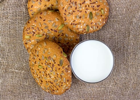 Homemade cookies and milk on textile surface