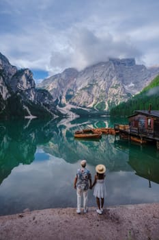 Couple of men and women at Lago Di Braies Italy, Pragser Wildsee in South Tyrol, Beautiful lake in the Italian alps, Lago di Braies. vacation Italian alps mountain lake