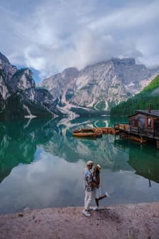 Couple of men and women at Lago Di Braies Italy, Pragser Wildsee in South Tyrol, Beautiful lake in the Italian alps, Lago di Braies.