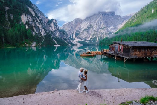 Couple of men and women at Lago Di Braies Italy, Pragser Wildsee in South Tyrol, Beautiful lake in the Italian alps, Lago di Braies.