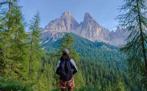 young women hiking at the dolomites mountains in Italy. Italian alps