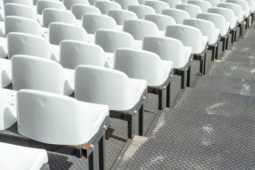 Seats of tribune on sport stadium. Concept of fans, chairs for audience, cultural environment concept. mpty seats, modern stadium