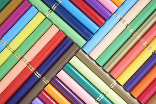 Set of colored pencils stacked in row closeup. Set of colorful pencils creativity artistic skill and school