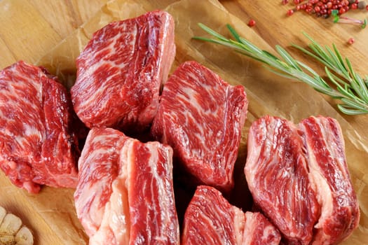 Raw beef meat on a cutting board with a knife, spices. Cooking