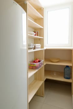 Food storage, wooden shelves in the pantry, kitchen utensils.