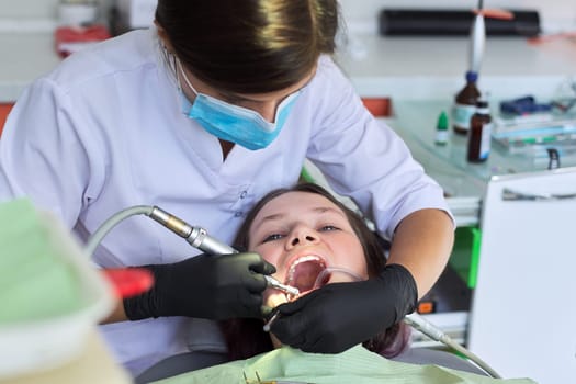 Close up dental treatment procedure in dental office. Dentistry, healthy teeth, medicine and healthcare concept