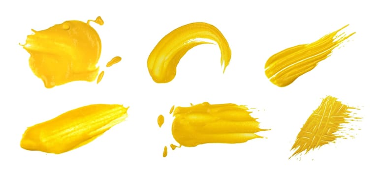 Close up collection of different yellow American mustard wet stains isolated on white background, top view, directly above