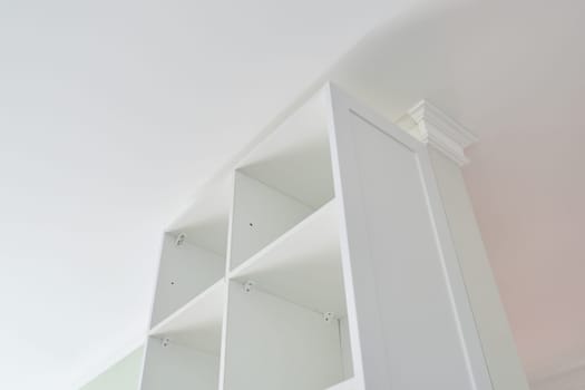 Furniture installation, white cabinet in the interior of the house.