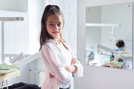 Smiling teenager girl in the dental office.