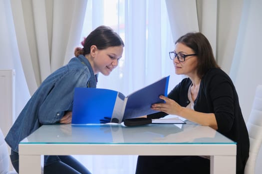 Female teacher teaching teenage girl individually, private lessons, help with exams