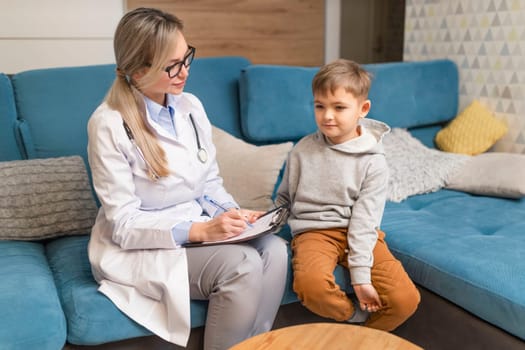 A family doctor examines a little boy at home. Pediatrician girl treats a child.