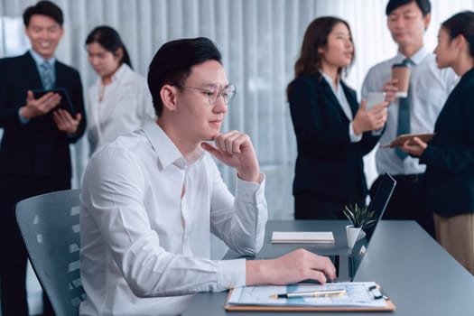 Portrait of focus young successful confident male manager, executive wearing business wear in harmony office arm crossed with blurred meeting background of colleagues, office worker.