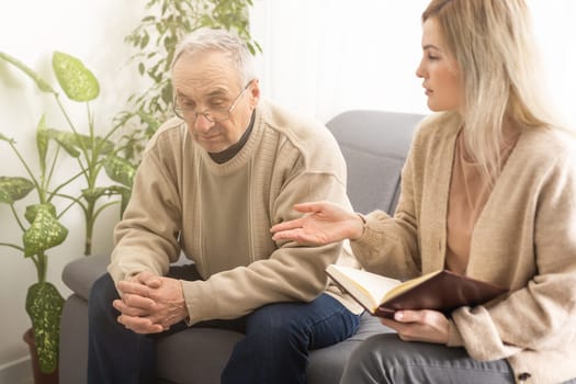 Close up anxious serious old man listening to female doctor at meeting in hospital, therapist physician consulting mature patient about disease, treatment, elderly generation healthcare concept.