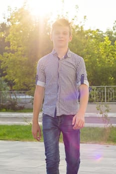 Outdoor portrait of teenage boy 14, 15 years old. Urban background.