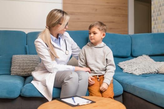 Pediatrician examines a sick child. Sick boy in the clinic. Children's home treatment of the virus.