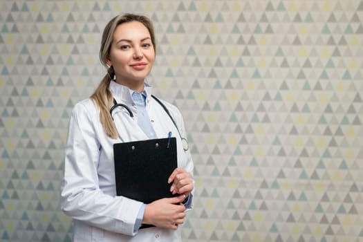 Photo of attractive family female doctor consulting patients beaming friendly smiling, white lab coat and stethoscope.