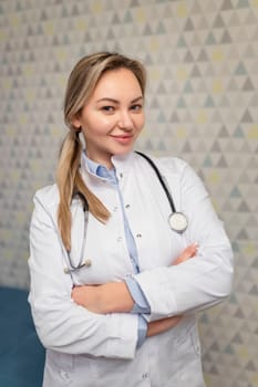 Photo of attractive family female doctor consulting patients beaming friendly smiling, white lab coat and stethoscope.