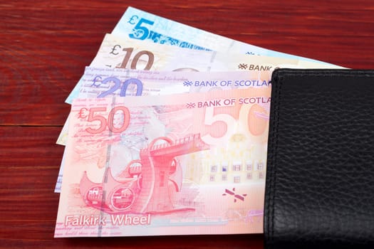 Pound Scots in the black wallet