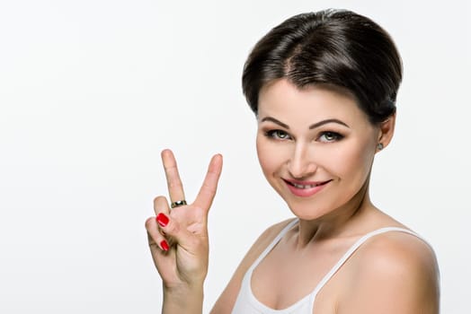 Head shot, beauty portrait of middle aged woman on white isolated background. Smiling female with hairstyle makeup looking at camera. Mature age, 40s, health, skin care, cosmetics concept