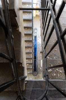 Top view of an old rectangular spiral staircase in an old abandoned building