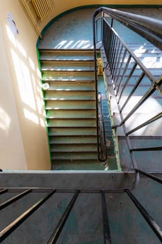 Top view of an old rectangular spiral staircase in an old abandoned building